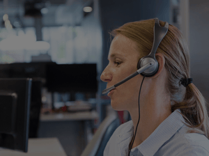 Associate talking into a headset to represent how Pathstream university certificate programs for health plan operations teams result in happier customers.